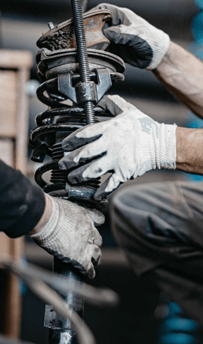 Mechanics working on suspension components