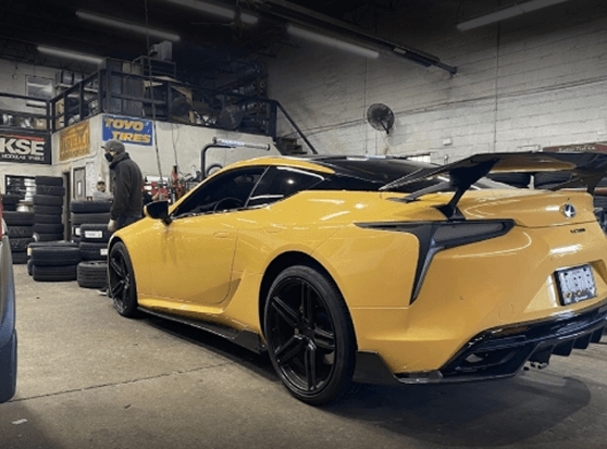 Yellow sports car inside the workshop