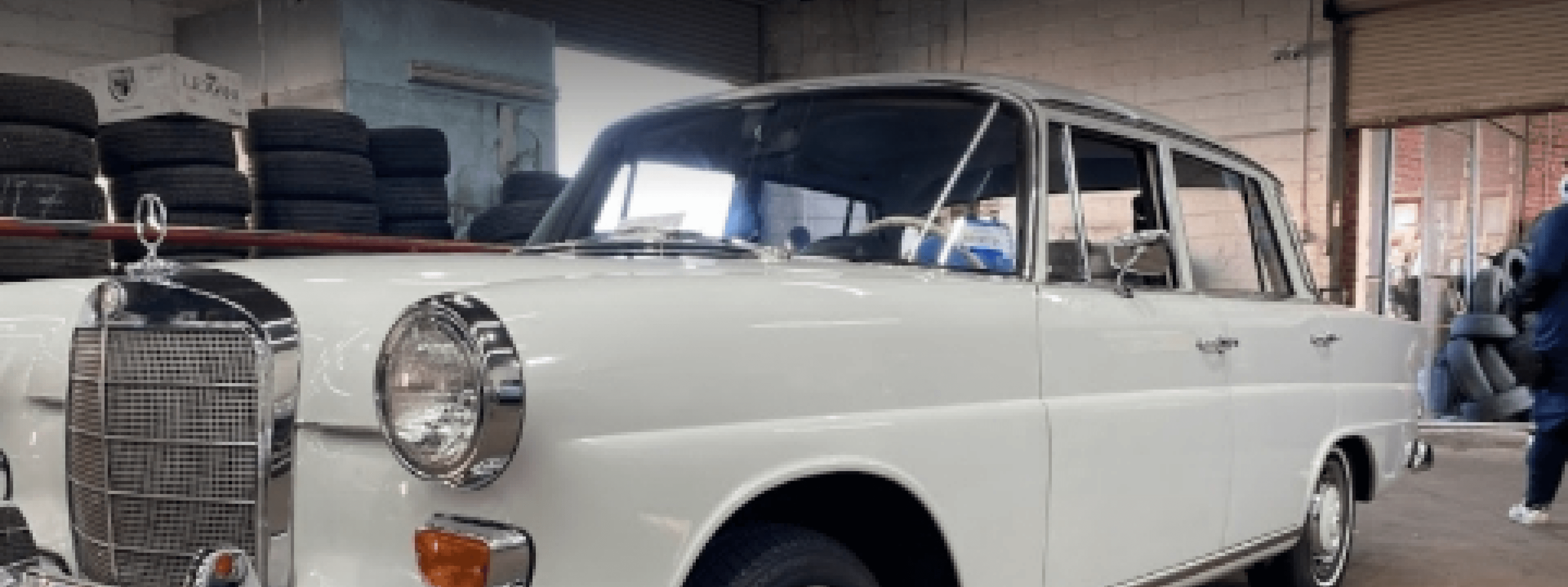 Classic white sedan inside the workshop